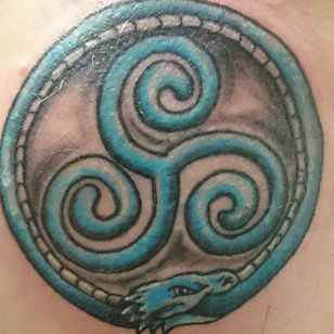 Triskelion surrounded by ouroboros serpent by Angi at Dr Feelgoods