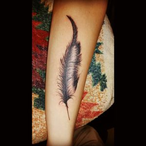 Feather on forearm. Black and white.