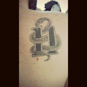 My first ever tattoo. Im a racer. A sidecar passenger. The moves of a passenger need to be smooth like a snake. 11 is my licky number and is a symbool for crazy in Holland.