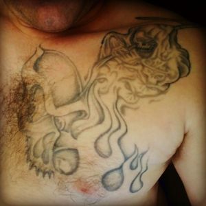 Yeah this is my chest pice the skull and flames i got done in prison so i had to keep it light when going up to the reaper the reaper i got done in a shop i think it looks good but i don't know what im going to do around it