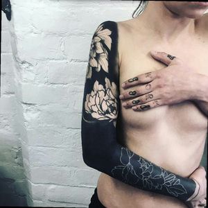 Awesome solid black with negative peony flowers sleeve tattoo