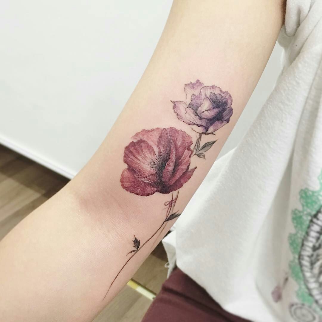 Orange rose and poppy tattoos on the left inner