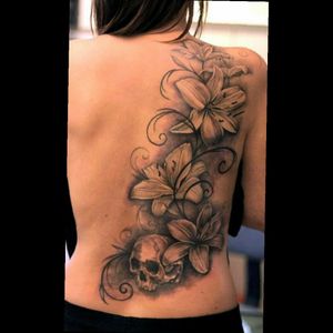 Designing a personal piece with similar lilies, a rosary, and cross to go from my shoulder down my back to my upper thigh