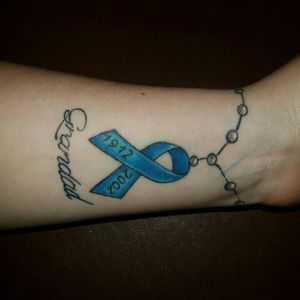 Cancer ribbon with grandads dates in tails of the ribbon with rosary beads around the wrist. #cancertattoo  #Grandad  #rosarybeads #blue