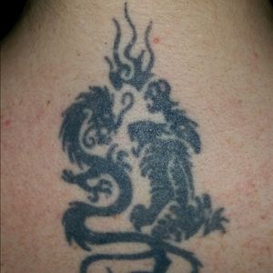 One of my first tattoos done on the back of my neck. A dragon fighting a tiger. Done in 1998