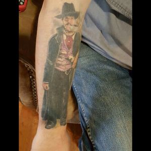 Val Kilmer as Doc Holiday from Tombstone I have this on top of my right forearm. I would like to finish my arm out as a sleeve. On the upper part of my arm I have a Maltese firefighting cross. Anyone have any suggestions or thoughts as how I could accomplish a sleeve on this arm?