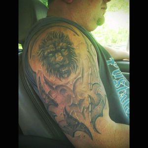Cover up of old lion with new stone faced lion with tribal.