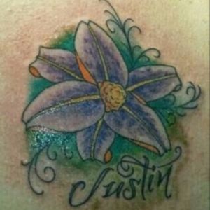 First tattoo on my right shoulder blade. My son's name. #firsttattoo#flowertattoo#sonsname