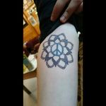 My friend's tattoo, she wanted to liven up her peace symbol so she had her sister, a newly trained tattoo artist, create this awesome mandala around it.