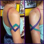 Interesting colour lines morph & cross-over tattoo