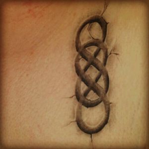 Double infinity on left side of chest.