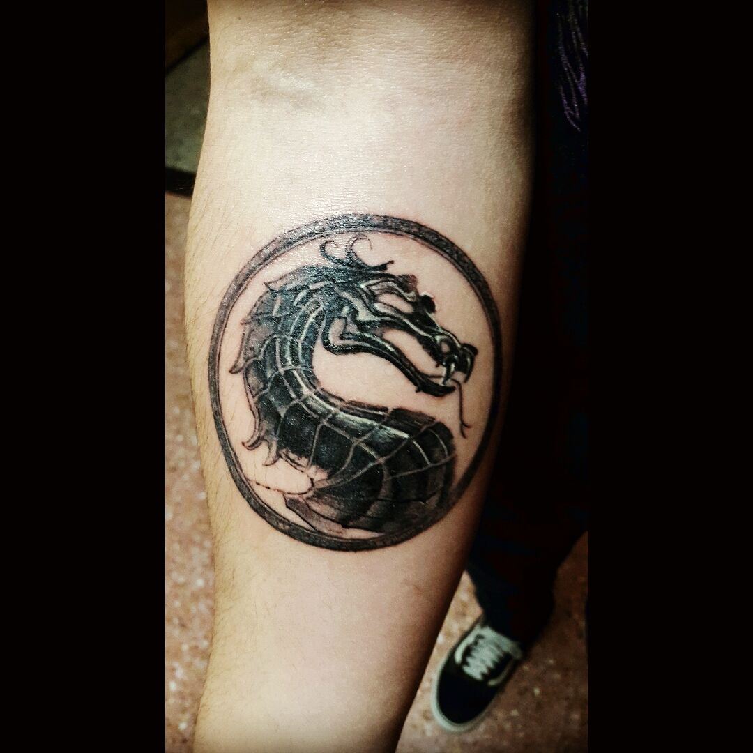 This is a tattoo thats still a work in progress I got the MK logo plus  Scorpion Im gonna get Sub Zero next to Scorpion and Im gonna do a ice  background