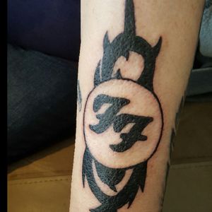 My tattoo with my husbands ashes he loved foo fighters I love slipknot so put them together and got this