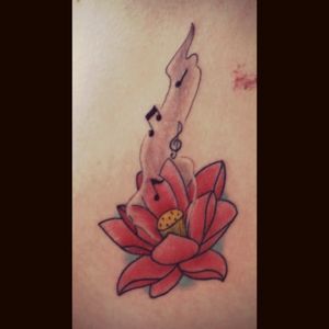 My first tattoo of a lotus with music notes coming out of it showing how music has opened me up