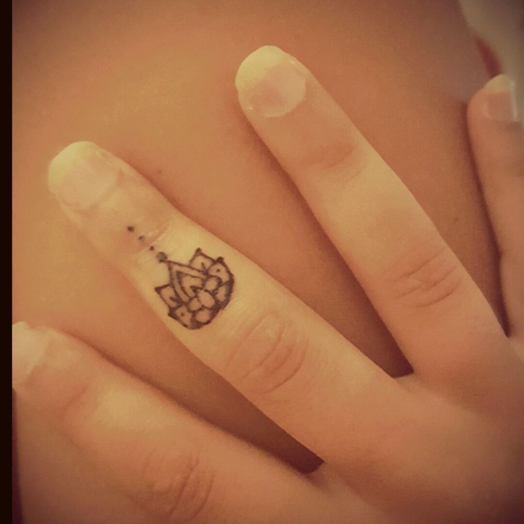 Tiny minimalist lotus flower tattoo on the middle