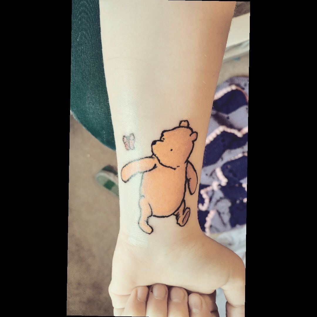 Fine line Pooh tattoo located on the ankle