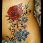 #music #rose #forgetmenot #flowers #tattoogirl #colombiantattoo tattoo by Sebastian Vinasco