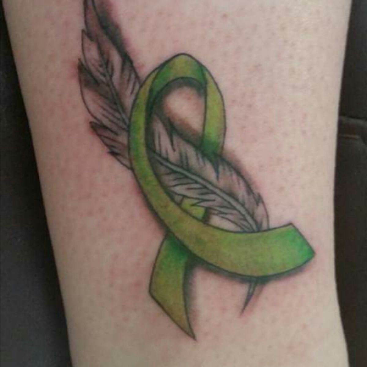 Tattoo uploaded by Toni • Feather with the ribbon for cerebral palsy