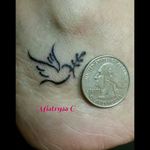 Tiny dove on the ankle