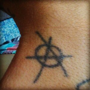 Anarchy Symbol ( Jail house tattoo, done woth staple and soot )