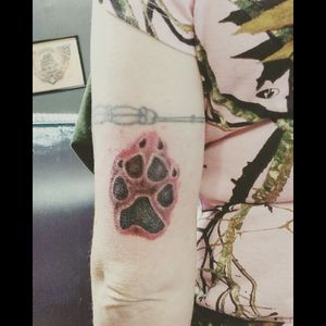Our puppy's actual paw print tattooed on the back of mt left upper arm.