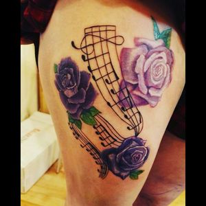 Musical notes from ironic by Alanis morrisett with roses on my leg a song that reminds me of better times <3