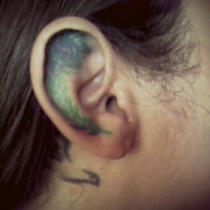 Peacock feather on my ear I want to redo and a dove behind my ear