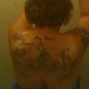 I know the pic is kind of blurry but its jus the camera on my tablet. Here I have my 3 grandkids names on top left shoulder,an angel with my daughter's name, a fairy,a parrot and 4 star gazer Lillie's with vines