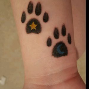 Paw prints that I got for my cats. The one with the star is for my cat Stella, which is star in Italian and the one with the moon is for my cat Luna, which is moon in Italian.