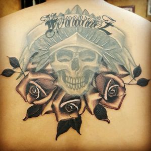 My back tattoo got from the skull to the top of the feathers on my 18th b-day and a few years later got the roses added just recently, and my last name touched up!
