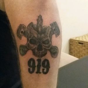 Motorcycle club number with a piston skull