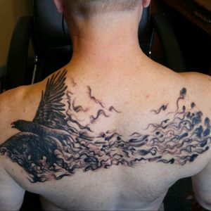 Crow flying out of the darkness, symbolizes my work in human services- helping people find their way back to the light. Done by Greg at Bury the Needle, in Barre, VT.