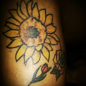 Assortment of flowers near my left knee- Sunflower from New OrleansTulip from Amsterdam Rose from Sins & Needles in New York (Friday the 13th tattoo)