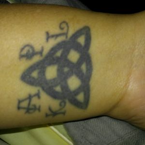 Triquetra with my initial, my mom's and two sister's initials.  On my wrist.