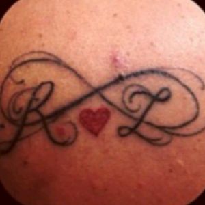 This my left back shoulder.. my husband's initials within the infinity symbol with a red heart.. #infinity #heart #husband
