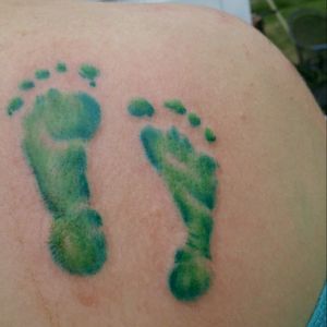 My baby brother was diagnosed with Acrania, a fatal skull defect, at just 12 weeks gestation. He lived 90 minutes after birth. These are his footprints in the awareness color for his defect, on my right shoulder.