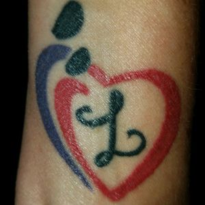 my first tattoo at the age of 47. i wanted to get a tattoo for each one of my kids. i started with my 6 yr old daughter, Liliana and got this mother/daughter symbol with each of our favorite colors and her initial.
