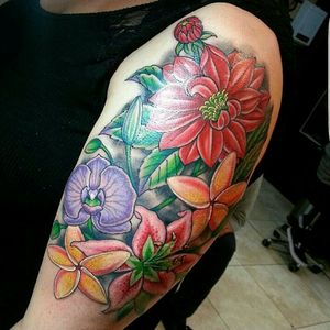 Flower arm piece #orchids #lilies #plumeria #flower #flowers #floraldesign #color #colortattoo #arm #girlytattoo #Tattoodo