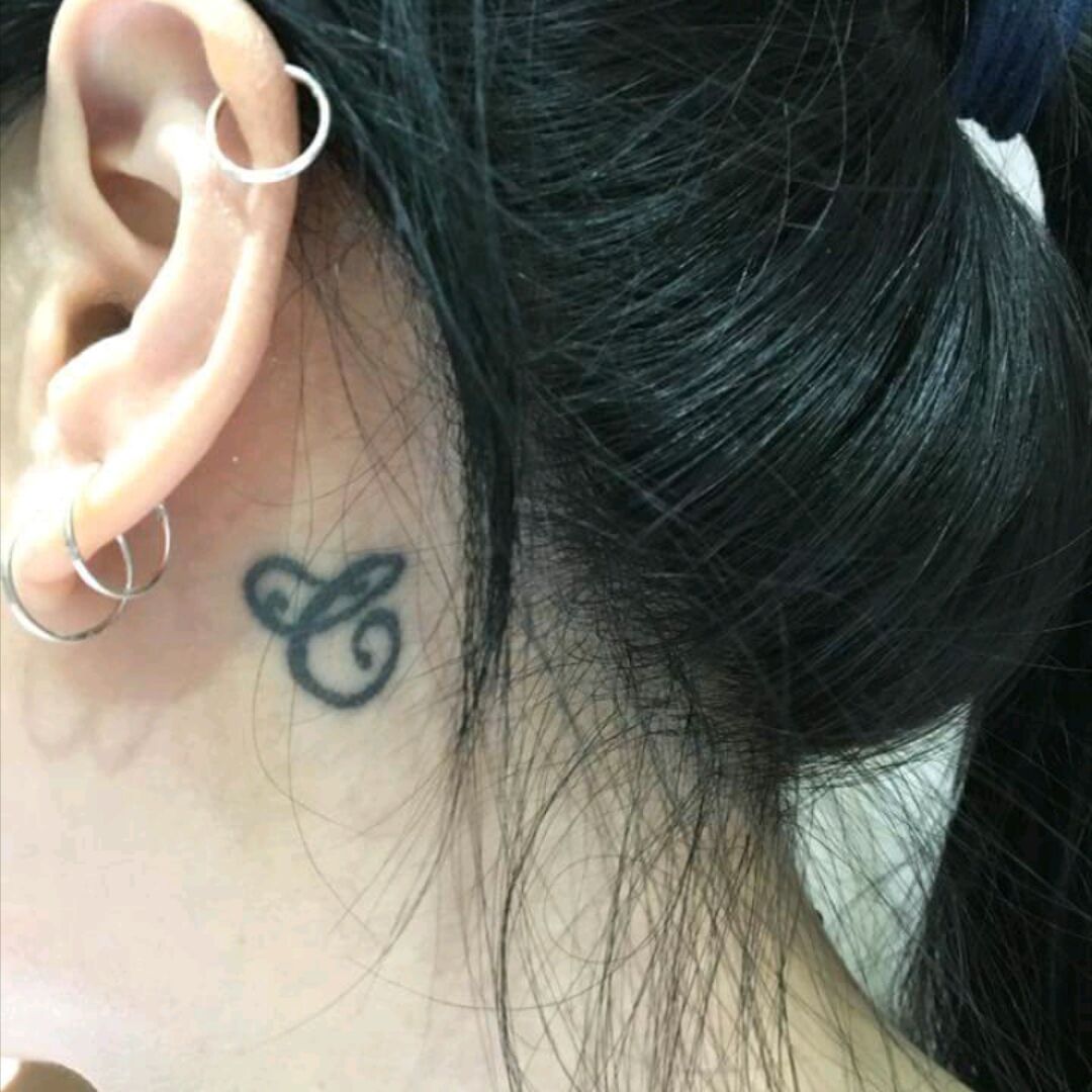 treble clef tattoo behind ear