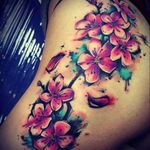 Beautiful vibrant small flowers along the hip trailing onto the upper leg #flower #pink #vibrant #hiptattoo