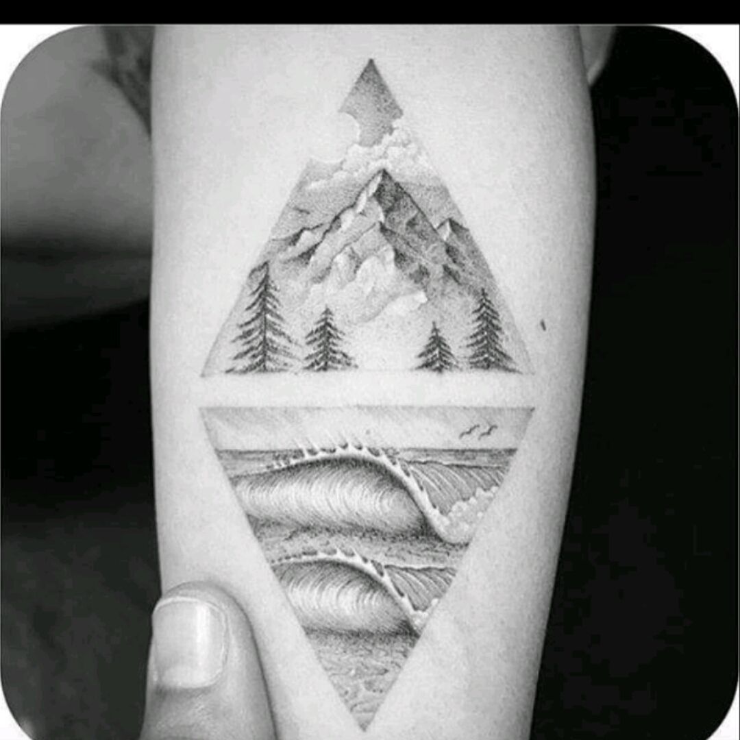 Mountain and wave tattoo on the inner forearm