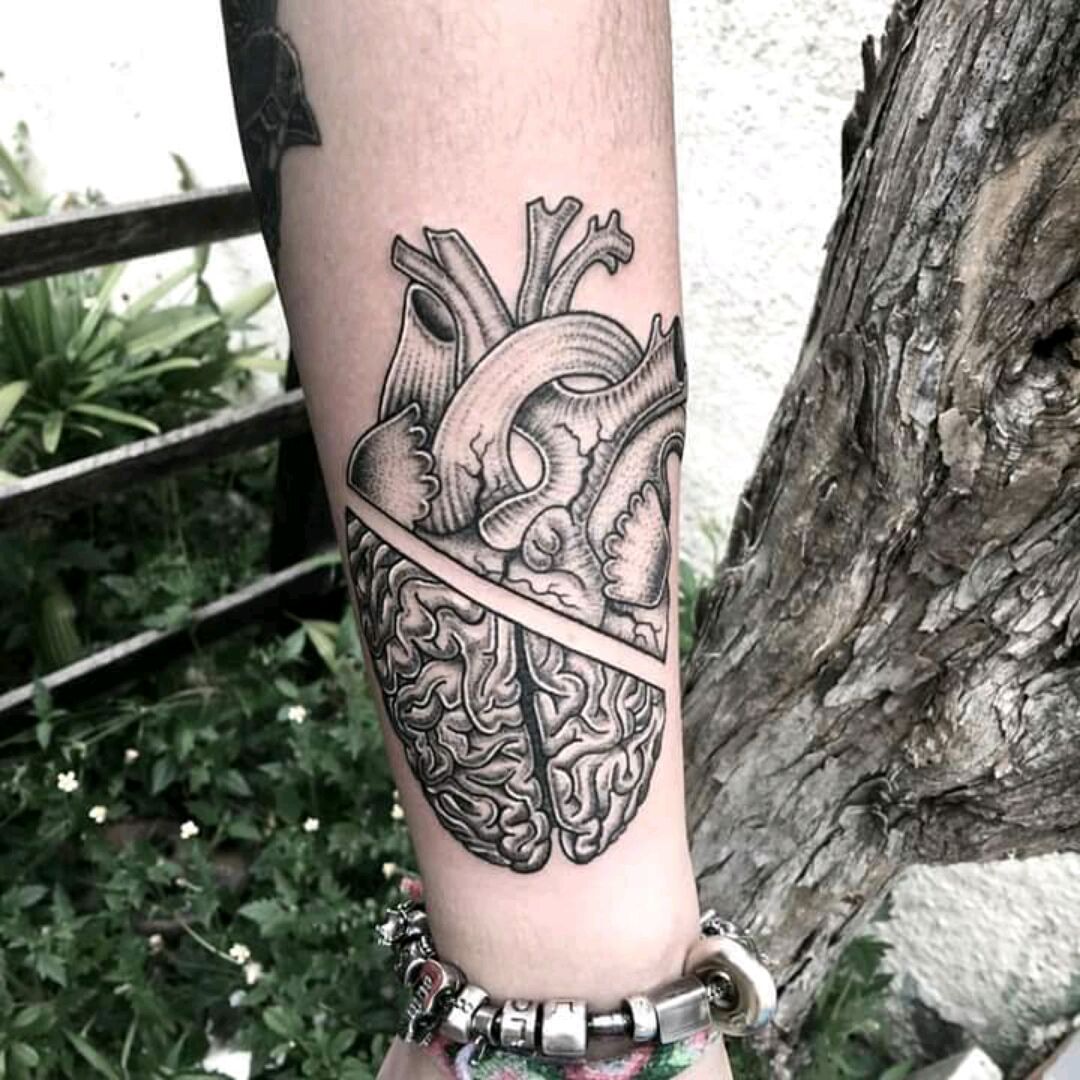 Heart vs Brain tattoo located on the tricep