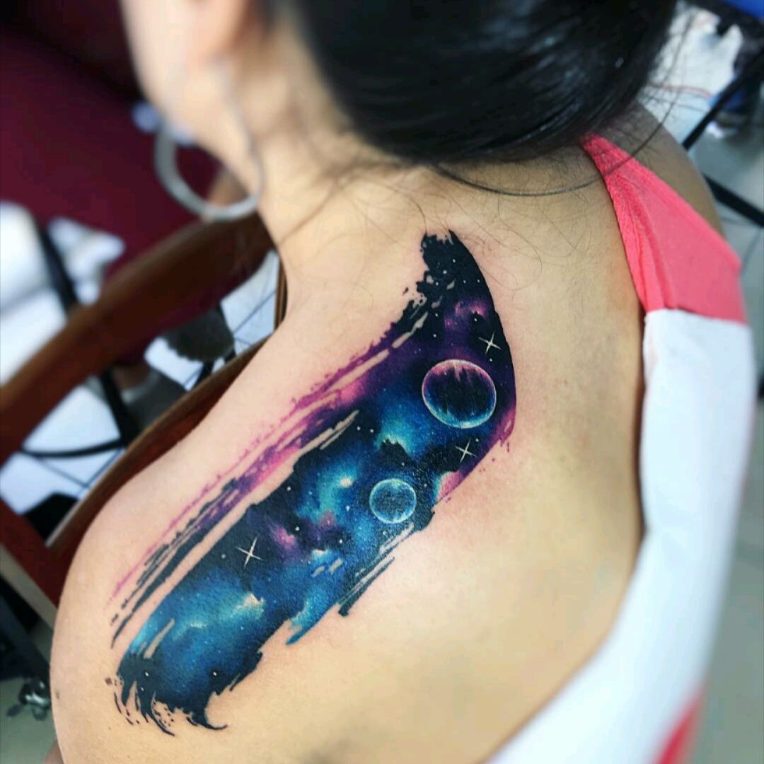 Galaxy tattoo on the upper back