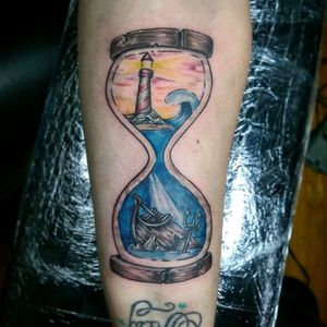 Hard to see how small this really was. About 5" tall on forearm. #lighthouse #small #water #hourglass #tattoo