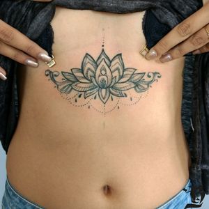 Lotus flower. Design provided by the client. #tattoo #blackink #lotusflower #underboobs #underboobstattoo #flowertattoos