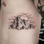 Mountain tattoo on the ribs.