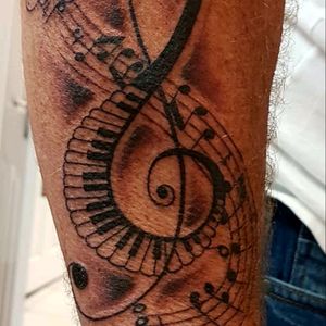 A treble clef with a music staff through it