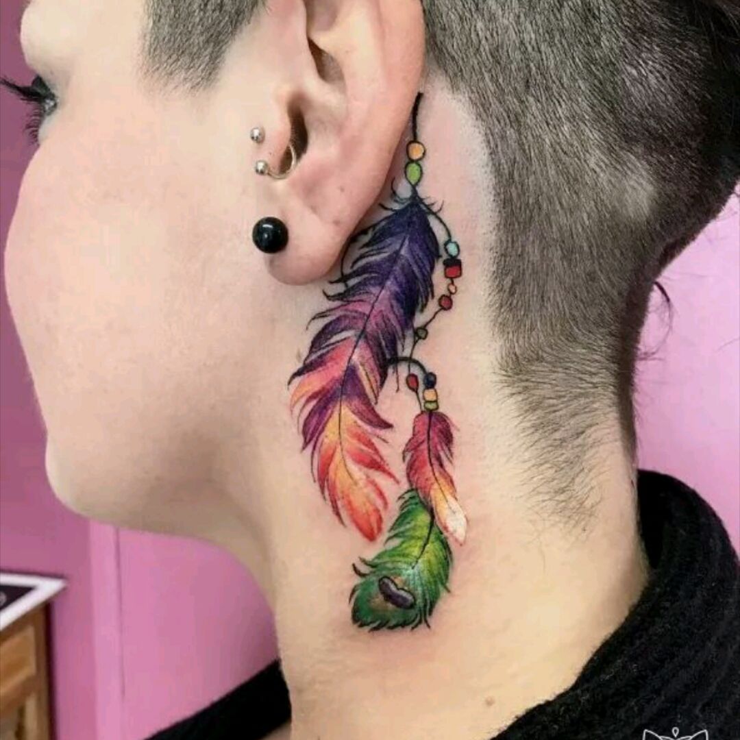 Fine line style ornamental feather tattoo on the back