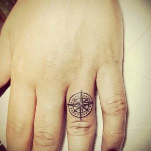 Compas finger tattoo