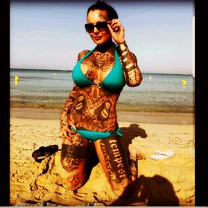 Relaxing at the beach ... more inked girls in bikini at www.tattoomasterpiece.info